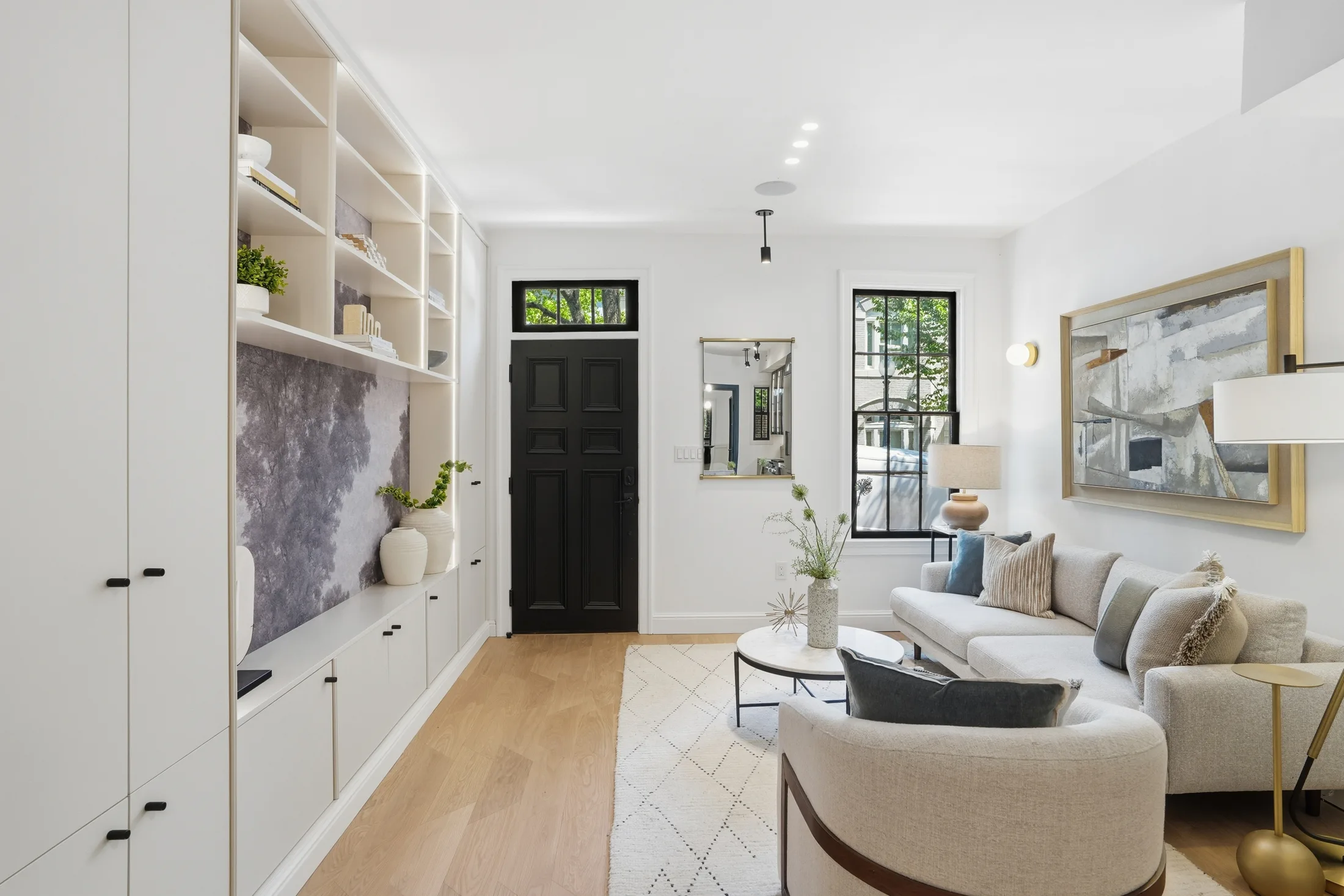 Living room with custom built-ins and oak floors at Casa Ulivo