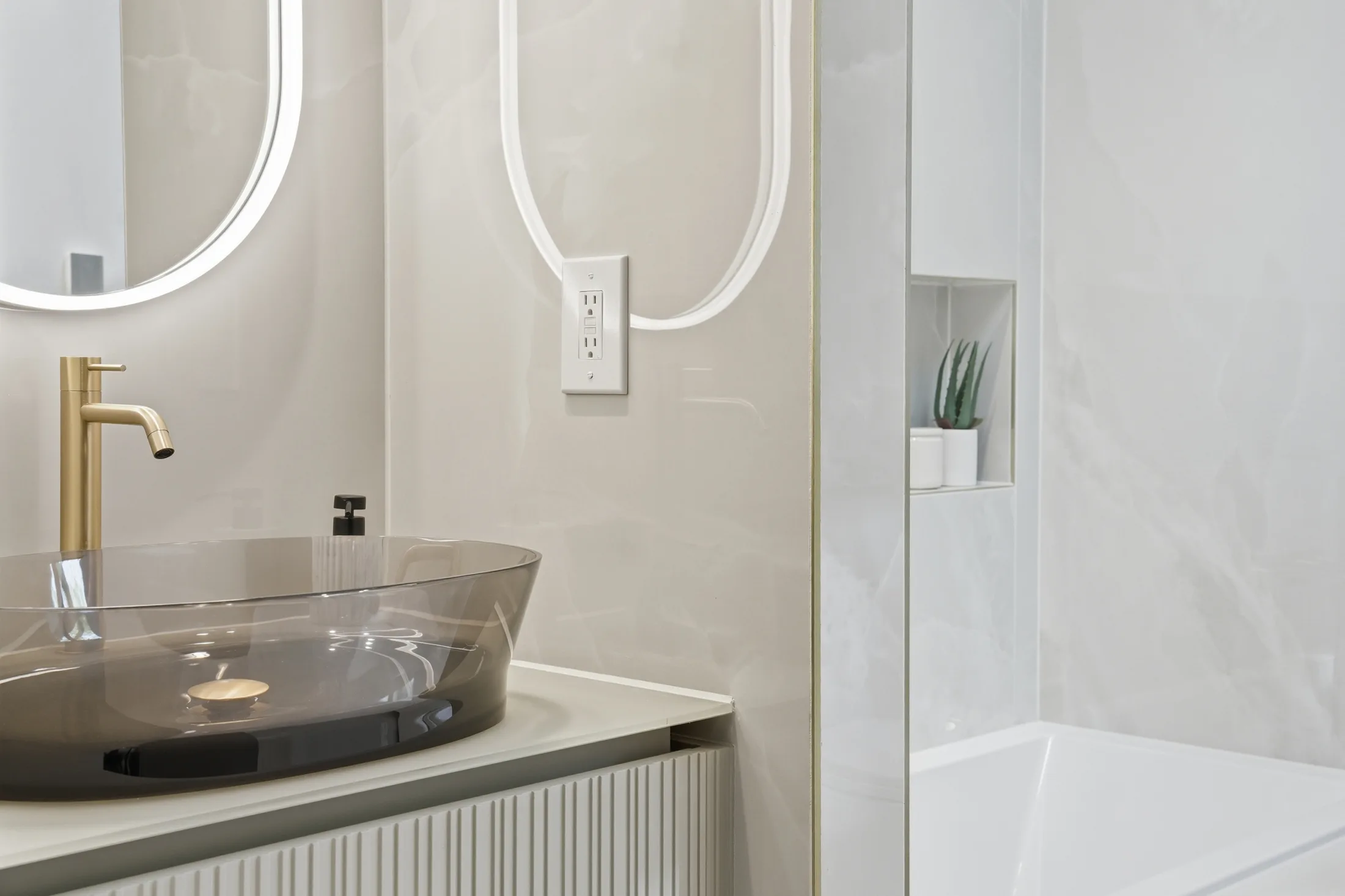 Smoked glass vessel sink with brushed gold faucet at Casa Ulivo