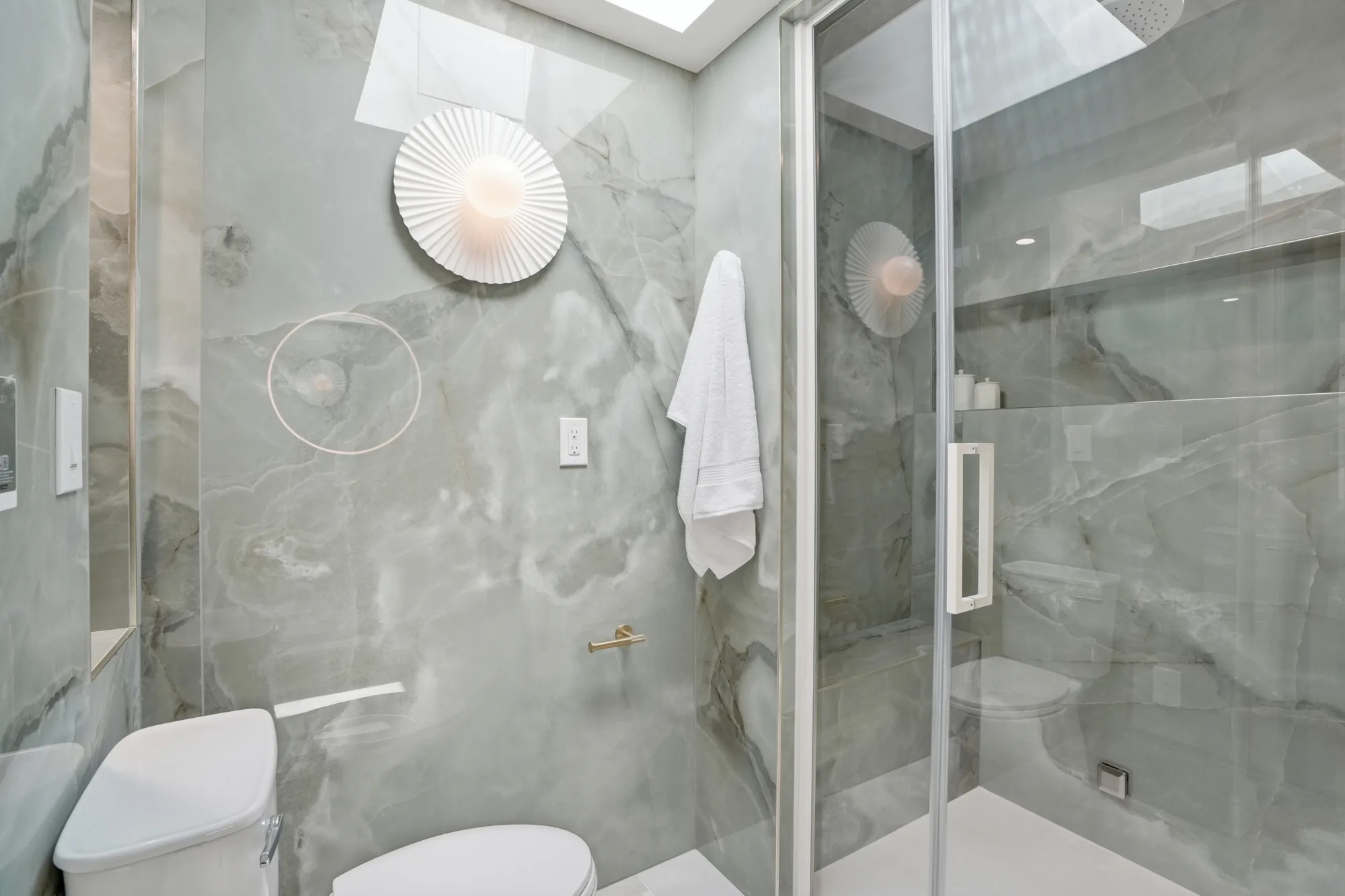 Onyx-toned porcelain bath with glass shower at Casa Ulivo