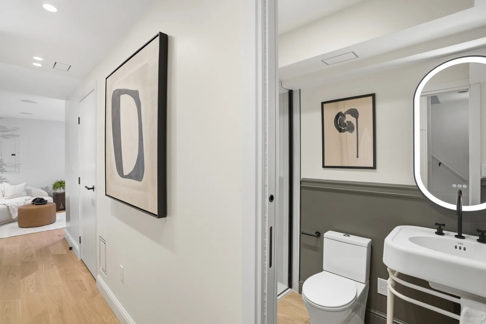 Main level bath with steel console sink basin and oval mirror at Casa Ulivo